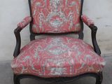 an old chair with a red and white upholstered upholstered seat