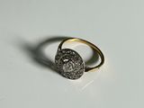 an image of a gold and diamond ring on a white surface