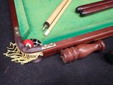 a pool table with a pool cues and a pool ball on it
