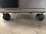 a close up view of a silver stove with wheels