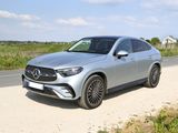 the mercedes gle suv is parked on the side of the road