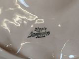 a close up of a white plate with a black writing on it