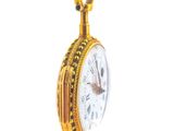 a gold pocket watch hanging from a chain on a white background