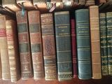 many old books lined up on a shelf