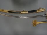 a close up of two swords on display on a table