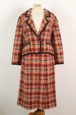 an orange and black plaid coat on a mannequin mannequin