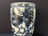 blue and white vase with a rooster on it on a table