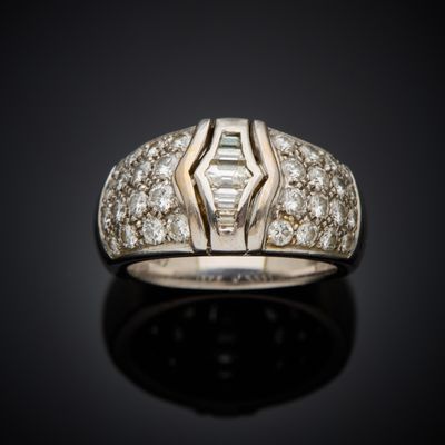 a close up of a diamond ring on a black surface