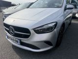 the mercedes cla is parked in a parking lot with other cars in the background