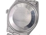 a silver watch that is sitting on a white surface