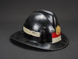 a close up of a black hat with a red and white stripe