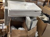 a pile of boxes and boxes of electronics on the floor