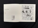 an open book on a black cloth with a drawing of a man in a suit