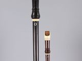 a pair of flutes with wooden handles on a table