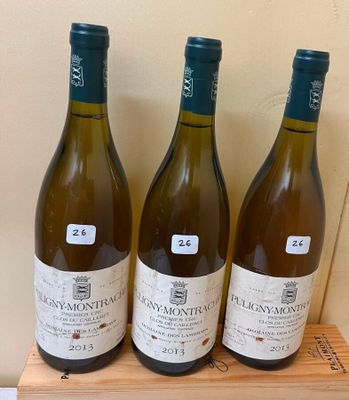 three bottles of wine sitting on top of a wooden box