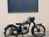 a black motorcycle parked on the side of the street