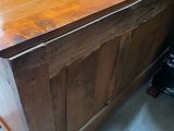 a wooden counter with a wooden top in a room