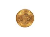 a close up of a gold coin on a white surface