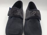 a pair of black sued shoes on a white surface