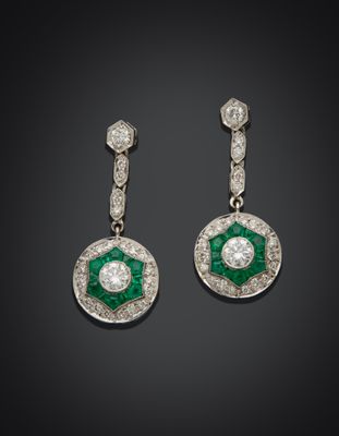 a pair of emerald and diamond earrings