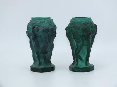 two green vases sitting next to each other on a white surface