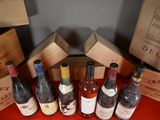 several bottles of wine are lined up on a red table