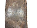 an old book that is sitting on a white surface