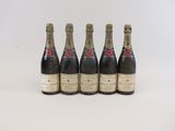 quatre bouteilles de champagne sont alignées sur une surface blanche