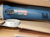 a blue and white electric sander sitting on a cardboard box