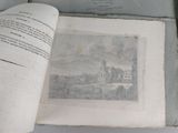 an open book with a picture of a castle on it
