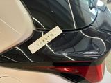 the rear end of a white car with a sticker on it ' s trunk