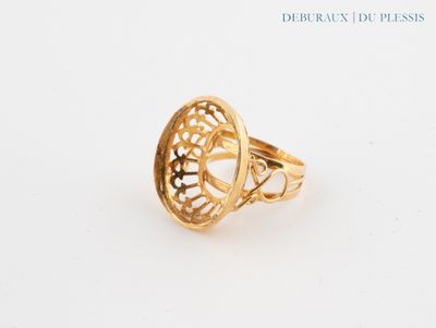 a close up of a gold ring on a white surface