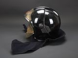 a helmet that is sitting on the ground next to a cloth