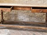 an old wooden desk with two drawers on it