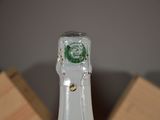 a close up of a bottle of wine with a clock on it