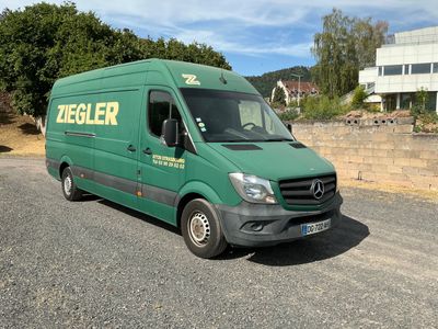 a green van that is parked on the side of the road