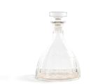 a clear glass bottle with a small amount of liquid in it