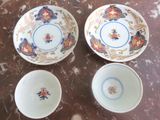 three bowls and a plate sitting on a table with a marble surface