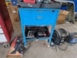 a blue cart with tools on it in a garage