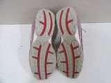 pair of red and white tennis shoes sitting on top of a white surface