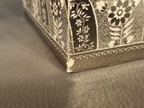 a black and white photo of a box on a couch