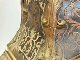 a gold and blue clock sitting on top of a table