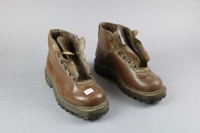 pair of brown leather boots with zippers on them on a white surface