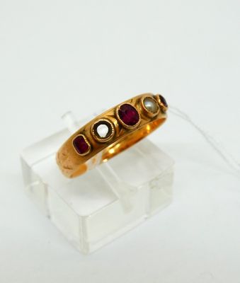 an image of a gold ring with garnets on it