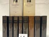 several books are lined up on a table with a number of them