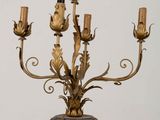 a gold colored candle holder with a bird on top of it