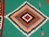 an image of a colorful rug with a diamond design