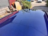 an image of a blue car parked in a lot