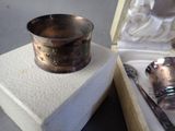 a silver spoon and a silver cup in a box