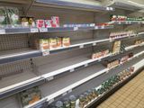many shelves in the store with canned food on them